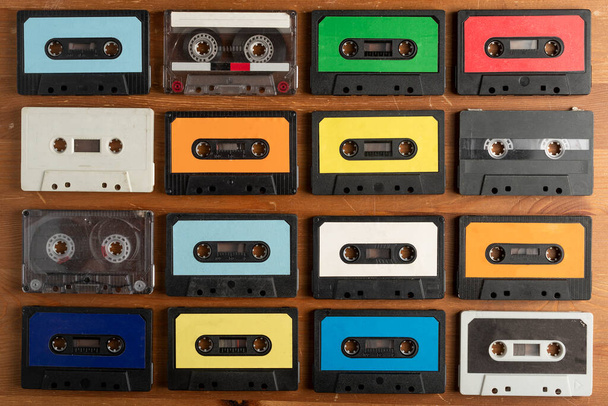 Vintage cassette tapes on wooden table background - Фото, изображение