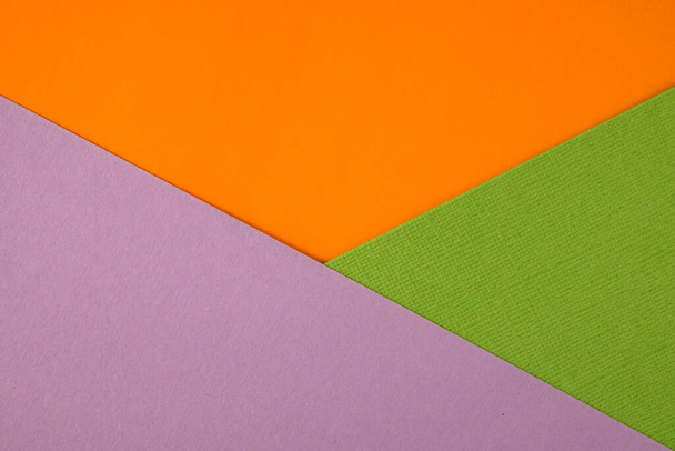Abstract geometric paper background. Green, violet and orange trendy colors.  - Photo, Image