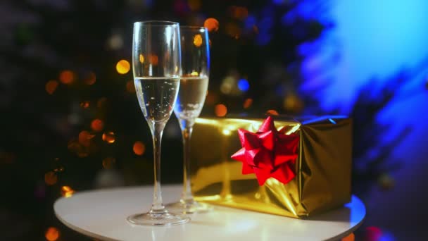Two glasses of champagne with gift. New year or christmas concept. - Filmati, video