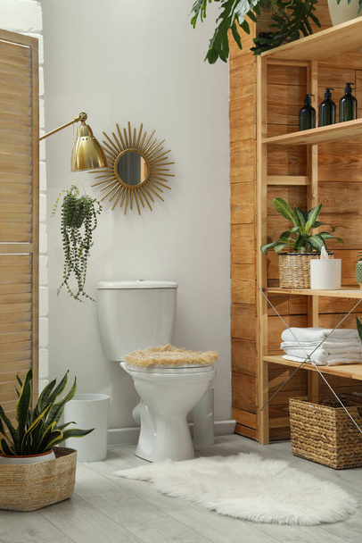 Toilet bowl and green houseplants in bathroom. Interior design - Foto, Bild