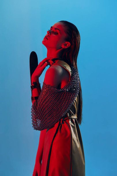 young woman Glamor posing red light metal armor on hand Lifestyle unaltered - Φωτογραφία, εικόνα