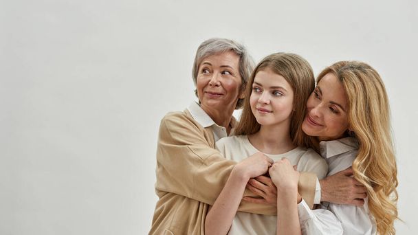 Grandma, mother and gramdkid hug and look away - Foto, immagini