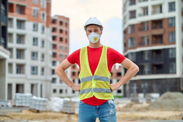 Man standing at construction site looking at camera - Zdjęcie, obraz