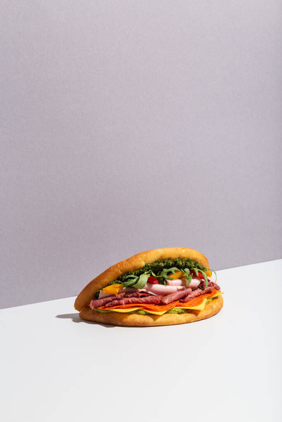 baguette sandwich with chicken salad on grey hard shadow - Foto, Imagen