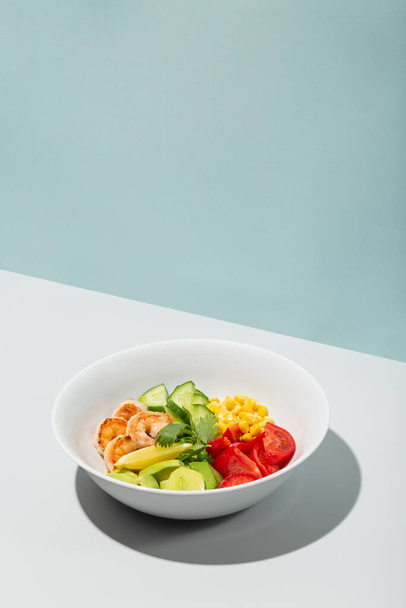 Fresh Avocado, shrimps salad with lettuce green mix, cherry tomatoes, herbs and olive oil, lemon dressing. healthy food - 写真・画像