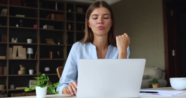 Serious thoughtful woman sit at desk working on laptop - Felvétel, videó