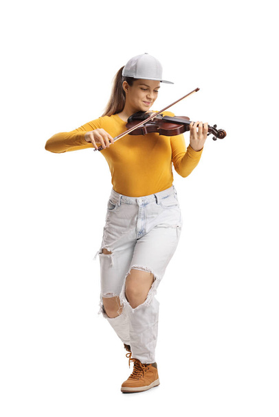 Young female violinist in jeans and yellow top playing a violin isolated on white background  - Φωτογραφία, εικόνα