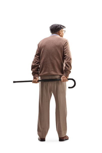 Full length rear view shot of an elderly man standing and holding a cane behind his back isolated on white background - Photo, Image