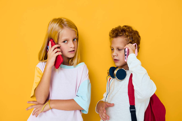 Photo of two small kids girl use gadgets with headphones - Foto, Imagem