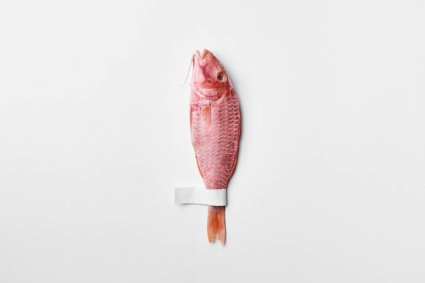 One salted air-dried surmullet with label on tail on white background - Photo, Image