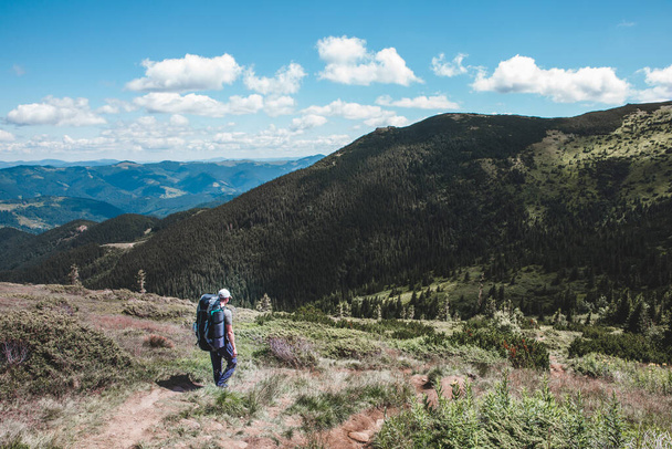 young hiker man in mountains. summer trekking path. copy space. - Fotoğraf, Görsel