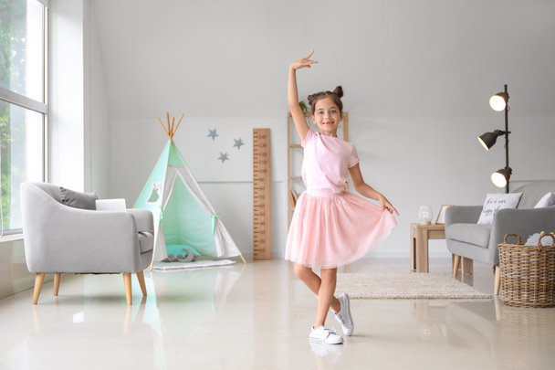 Adorable little ballerina dancing at home - Foto, Bild