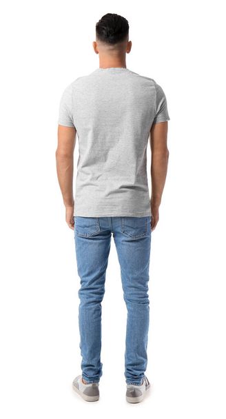 Schöner junger Mann in stylischem T-Shirt isoliert auf weißem Hintergrund, Rückseite - Foto, Bild