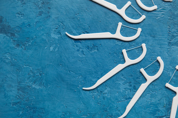 Floss toothpicks on blue background - Photo, Image