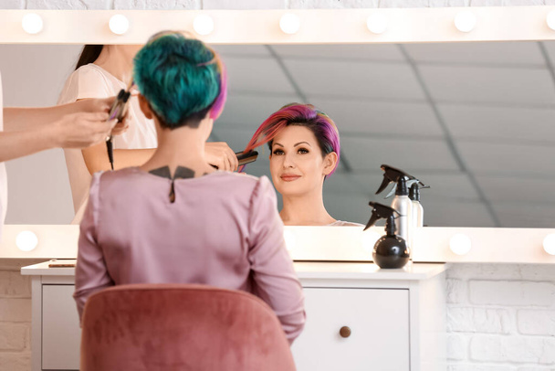 Estilista haciendo pelo de mujer en salón de belleza - Foto, Imagen