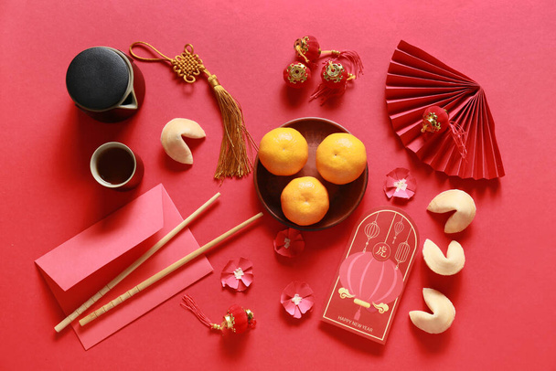 Red envelopes with Chinese symbols on color background. New Year celebration - Photo, image