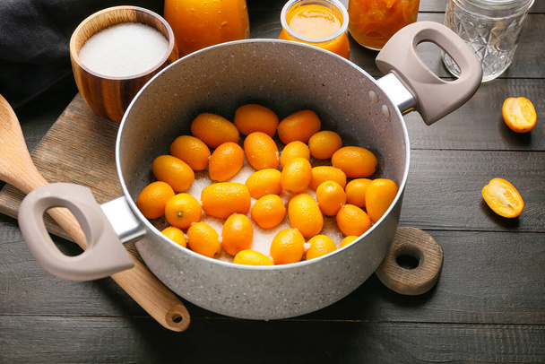 Preparing of tasty kumquat jam on table - Fotoğraf, Görsel