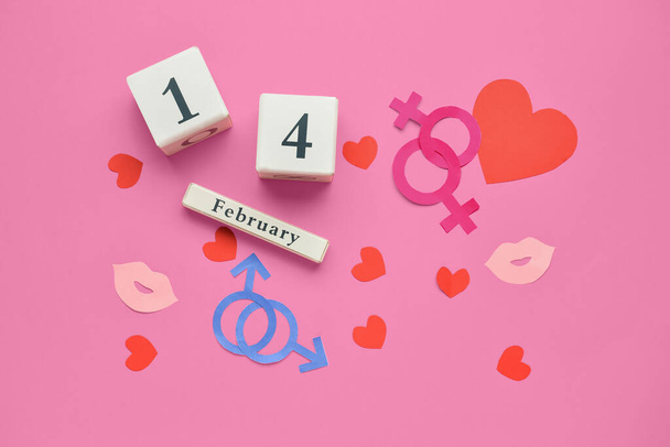 El calendario con la fecha del Día de San Valentín, los símbolos de la mujer y el hombre con los corazones sobre el fondo de color. Concepto LGBT - Foto, Imagen