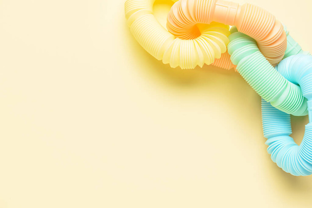 Different colorful Pop Tubes on beige background - Photo, Image