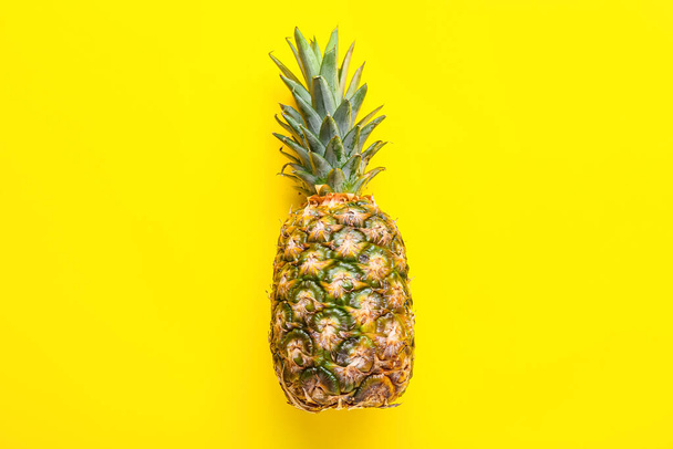 Fresh pineapple on yellow background - Фото, изображение
