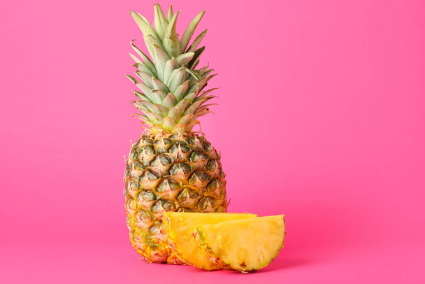 Fresh pineapple on pink background - Valokuva, kuva