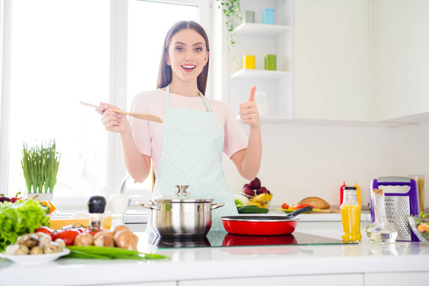 Photo portrait young woman cooking trying new dish showing like sign - Foto, afbeelding