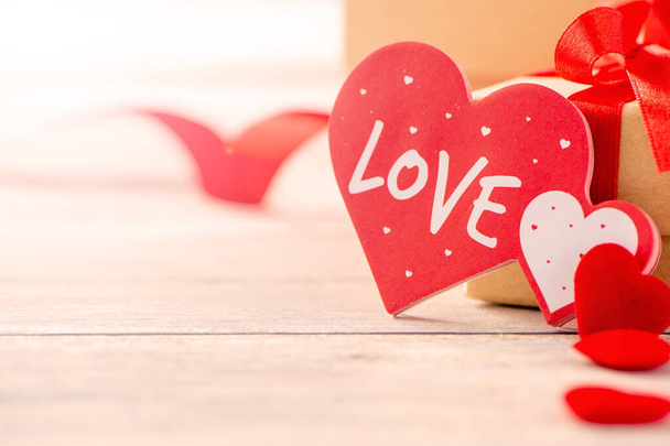 Concept of Valentine, anniversary, wedding celebration, heart shapes on a white wooden bench, bokeh background, close up - Zdjęcie, obraz