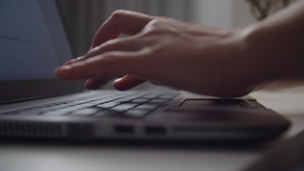 Manos femeninas escribiendo en el teclado del ordenador portátil en interiores. Primer plano de tiro en movimiento - Metraje, vídeo