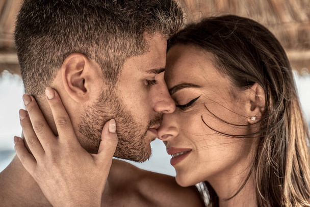 Portrait of attractive couple in love embracing each other. Closeup photo of young beautiful people hugging and kissing. Romantic moment. Valentine's day. Honey moon - Fotoğraf, Görsel