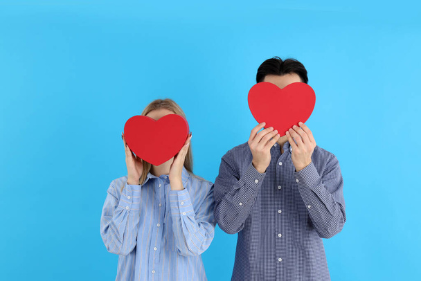 Cute couple with hearts on blue background - Φωτογραφία, εικόνα