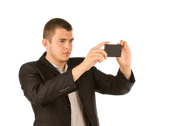 Young man taking a photo with his mobile phone - Foto, Imagem