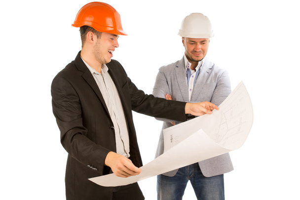 Architect holding a plan watched by his partner - Photo, Image