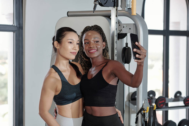 Female Friends Taking Selfie in Gym - Photo, Image