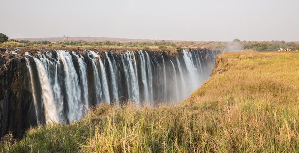 Panoramic view of Victoria Falls with toruists in Zimbabwe - Photo, Image