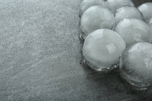 Many melting ice balls on dark grey table, closeup. Space for text - Foto, imagen