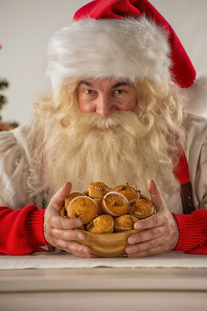 Santa Claus holding cookie - Photo, image