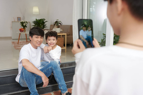 Father and Son Posing for Photo - 写真・画像