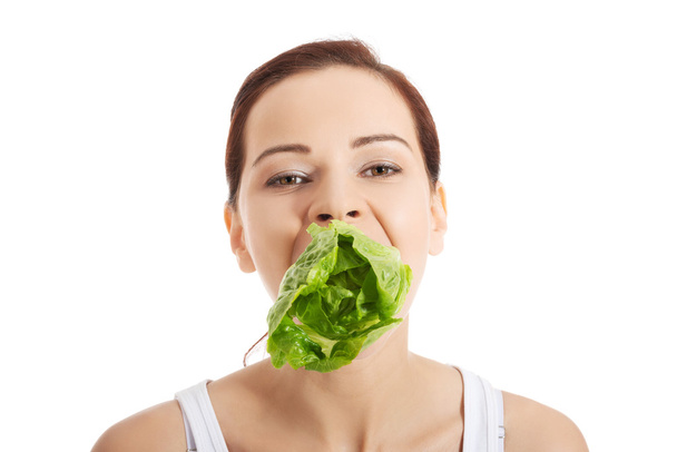 Smiling woman eating salat - Photo, Image