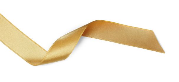 Beautiful golden ribbon isolated on white, top view - 写真・画像