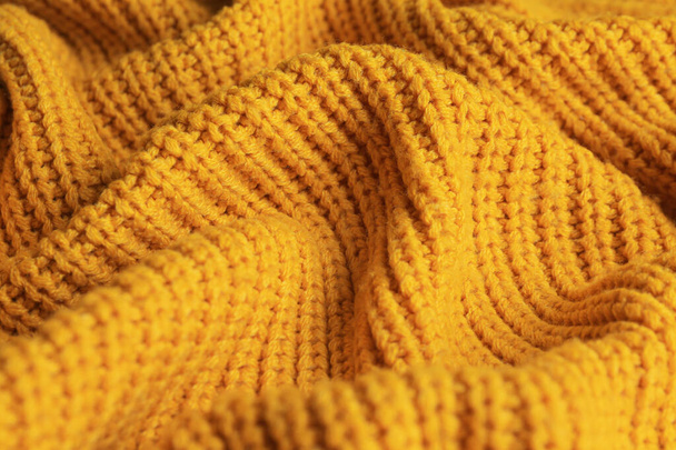 Beautiful orange knitted fabric as background, closeup - Foto, afbeelding