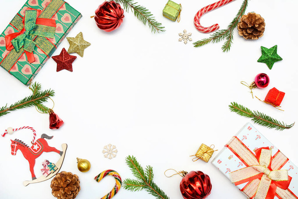 Christmas concept. Layout of New Years decor, toys, gifts and fir branches on a white background. Top view, copy space - Fotoğraf, Görsel