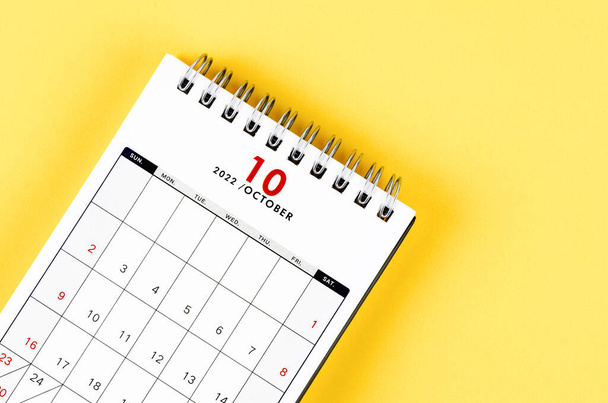 Close-up October 2022 desk calendar on yellow background. - Fotó, kép