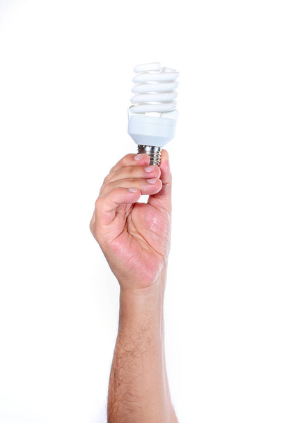 Bombilla fluorescente de mano aislada sobre fondo blanco. Eco concepto de luz - Foto, imagen