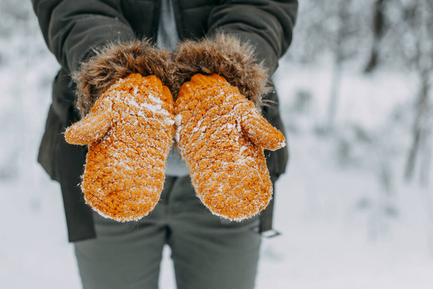 Knitted woolen mittens stained with white snow. winter time, snowball games, christmas holidays. - Φωτογραφία, εικόνα