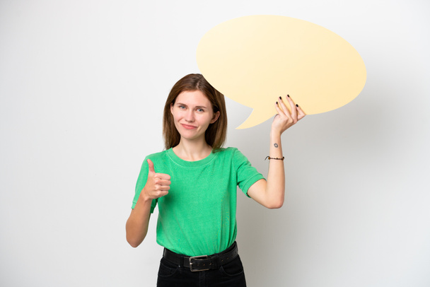 Young English woman isolated on white background holding an empty speech bubble with thumb up - Foto, immagini