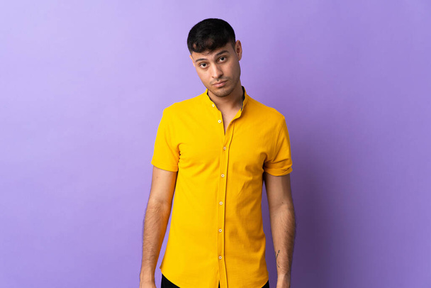 Young Colombian man isolated on purple background with sad expression - Foto, Imagem
