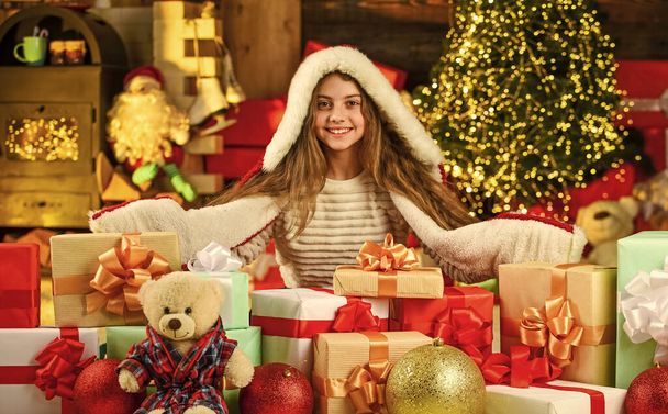 Jingle bells. Kid enjoy the holiday. winter holiday and vacation. kid with gift. free time and joy. kid in santa costume at christmas present. morning before Xmas. Cute little girl with gifts - Foto, afbeelding