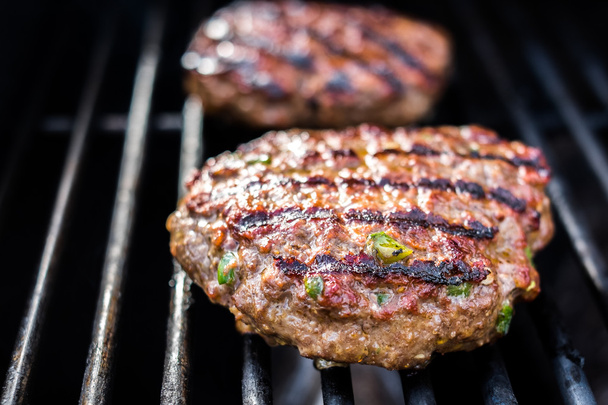 Hamburgers on the grill with stripes outdoors - Photo, Image