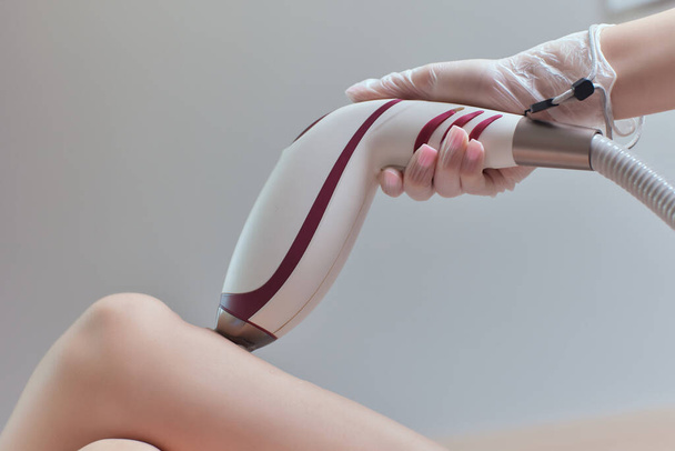 Young woman getting laser hair removal on her thighs. - Valokuva, kuva