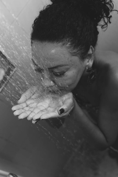 Portrait of a woman in the bathroom washing herself. Salvador, Bahia, Brazil. - Photo, Image